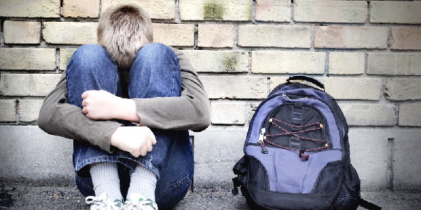 Upset boy against a wall
